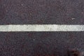 A white stripe on the old asphalt. Royalty Free Stock Photo