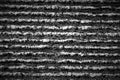 Horizontal stripes in granite. Dark gray striped background texture.