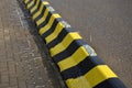 Horizontal stripes for traffic signs. highway concrete barriers on the road. vehicle lane separator. yellow color with black strip