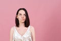 Horizontal Studio portrait of a beautiful brunette girl with a thoughtful preoccupied look.