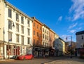 Horizontal sunrise view of the shops and cafes of West Strand Street in historic Rondout