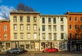 Horizontal sunrise view of the shops and cafes of West Strand Street in historic Rondout