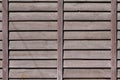 Horizontal texture of a wall from several rows of brown old wooden boards. Painted wooden wall in brown colo Royalty Free Stock Photo