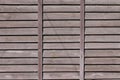 Horizontal texture of a wall from several rows of brown old wooden boards. Painted wooden wall in brown colo Royalty Free Stock Photo