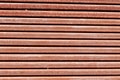 A horizontal textured background of very fine brick-colored stripes. Royalty Free Stock Photo