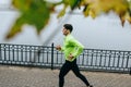 Horizontal top view image of young runner man running in the morning on the fog lake background. Fitness male exercising in the Royalty Free Stock Photo