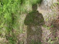 Horizontal version of the abstract background of the dark shadow of a man on a green field. Royalty Free Stock Photo