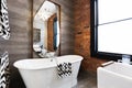Horizontal version freestanding vintage style bath tub in renovated warehouse apartment