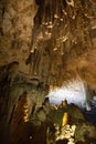 Horizontal view of the ceiling and floor of a cave with a close-up of stalagtites and stalagmites Royalty Free Stock Photo