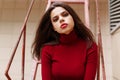 Horizontal view. Closeup face portrait of young woman with long hair, perfect makeup and red lips. outdoor shot. Royalty Free Stock Photo