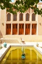 Horizontal view of the courtyard of an ancient house with windows in the style of oriental geometric architecture. Yazd, Iran