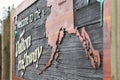 Horizontal view of Dalton Highway sign welcoming wooden sign with Alaska map.