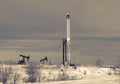 Oil field. Drilling rig and oil pump.