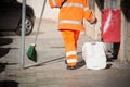Horizontal View of a Dustman Cleaning the Street With a Mop Wear