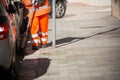 Horizontal View of a Dustman Cleaning the Street With a Mop Wear