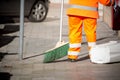 Horizontal View of a Dustman Cleaning the Street With a Mop Wear