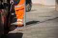 Horizontal View of a Dustman Cleaning the Street With a Mop Wear