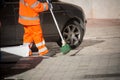 Horizontal View of a Dustman Cleaning the Street With a Mop Wear