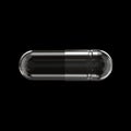 Horizontal View of Empty Transparent Medicine Capsule Pill Isolated on Black Background Close-Up. Royalty Free Stock Photo