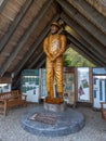 Horizontal view of the Forks Loggers Memorial, an A frame structure with a 12-foot logger statue