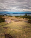 Horizontal view of Granite rocks, trees andin distance under rainy clouds