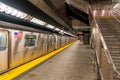 Horizontal view of a New York City Subway car waiting at the platform of the 34 Street-Hudson