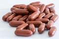 Red brown large vitamin pills on a white background