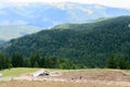 Horizontal view with sheepfold and mountains. Wooden sheepfold i Royalty Free Stock Photo