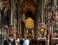Horizontal view of tourists visiting the interior of the Romanesque and Gothic style St. Stephen\'s