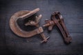 Horizontal view two old clamps on vintage wood board Royalty Free Stock Photo