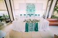 The horizontal view of the wedding table set in blue and white colours decorated with flowers. Royalty Free Stock Photo