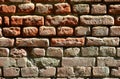 Horizontal wall texture of several rows of very old brickwork made of red brick. Shattered and damaged brick wall with pinched co Royalty Free Stock Photo