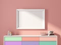 Horizontal white poster Frame Mockup hanging above colorful chest on pink wall