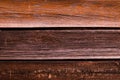 Horizontal wooden background composed of three parallel boards dark brown weathered