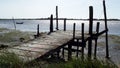 Wooden dock in low tide and bright sunny day Royalty Free Stock Photo