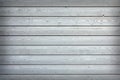 Horizontal wooden planks with grey paint on fence