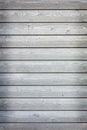 Horizontal wooden planks with grey paint on fence