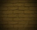 Horizontal yellow brickwork with damage. Dark yellow background with brick texture and vignette. The old wall Royalty Free Stock Photo
