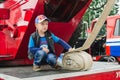 HORKI, BELARUS - JULY 25, 2018: The boy plays on the red cars of the rescue service 112 on a holiday in the park on a summer day