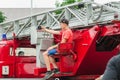 HORKI, BELARUS - JULY 25, 2018: A boy takes a selfie on a red car rescue service 112 on a holiday in the park on a summer day