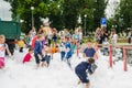 HORKI, BELARUS - JULY 25, 2018: Children of different ages play with airy white foam at the Rescue Service 112 holiday amid a crow