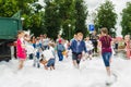 HORKI, BELARUS - JULY 25, 2018: Children of different ages play with airy white foam at the Rescue Service 112 holiday amid a crow