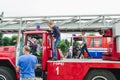 HORKI, BELARUS - JULY 25, 2018: Children of different ages play on the red cars of the rescue service 112 on a holiday in the park