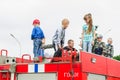 HORKI, BELARUS - JULY 25, 2018: Children of different ages play on the red cars of the rescue service 112 on a holiday in the park