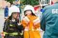 HORKI, BELARUS - JULY 25, 2018: Children in the uniform of lifeguards service 112 pose for a photo of a girl on a holiday