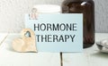 Hormone therapy -Diagnosis written on a white piece of paper. Treatment and prevention of disease. Syringe and vaccine