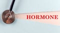 HORMONE word made on torn paper, medical concept background