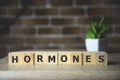 HORMONE word written on wood block, medical concept