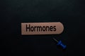 Hormones write on a sticky note isolated on office desk Royalty Free Stock Photo