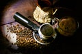 Horn, Turk and a cup of coffee on the background of coffee beans and vintage wooden table Royalty Free Stock Photo